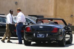 Arnold Schwarzenegger with Bentley Continental Supersports image.