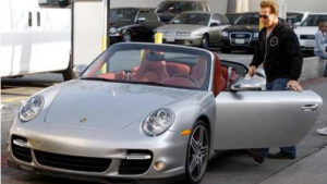 Arnold Schwarzenegger with Porsche 911 Turbo Cabriolet image.