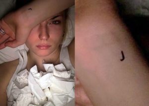 J tattoo on her wrist