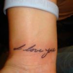 Khloe Kardashian tattooed line I Love you on right hands wrist