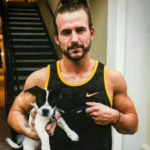 Adam Cole and his pet dog Image