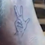 Luis has a finger tattoo in his left nake image.