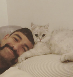 Sodhi and his pet cat image.