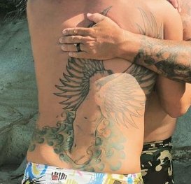 Taylor Kinney's back tattoos