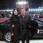 Andreas Pietschmann and his wife with his BMW car