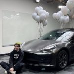 Devin Druid with his Tesla car