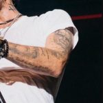 Marc Anthony's left hand and nake tattoos