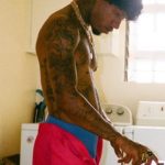 Tory Lanez's right hand and chest tattoos