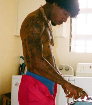 Tory Lanez's right hand and chest tattoos