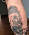 Sid Wilson Tattoo on leg