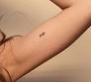 Lily Maymac Tattoo on left hand muscle