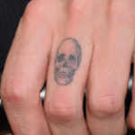 Jamie Campbell Bower Tattoo on fingers