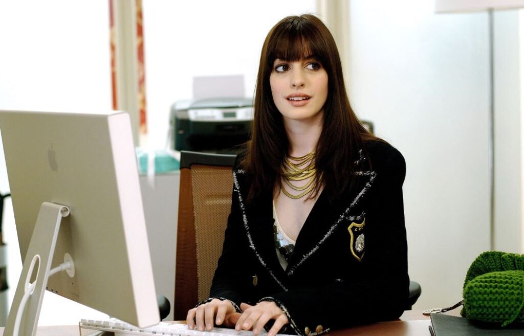Anne Hathaway as Miranda Priestly's assistant in The Devil Wears Prada – one of her breakthrough $1M+ salary roles
